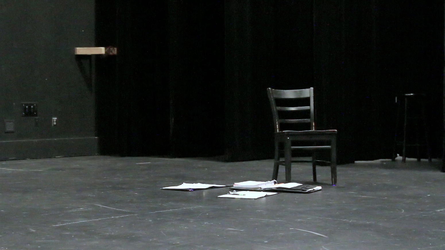 The Audition - A lone chair sits midstage