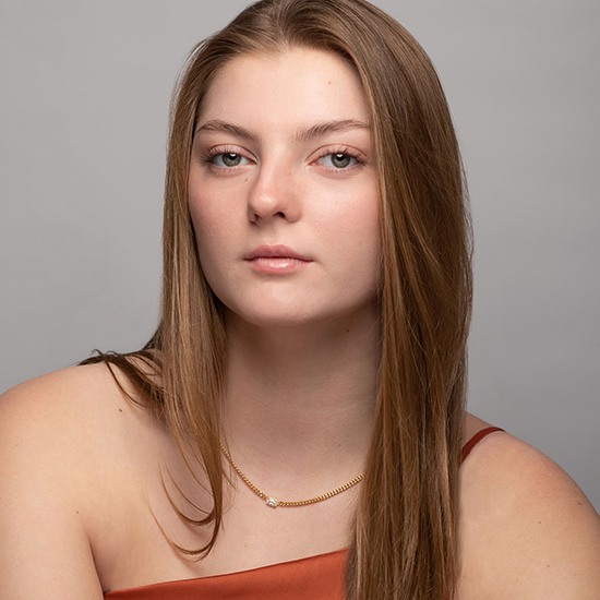 Lydia, in a formal portrait, sits for their picture to be taken.